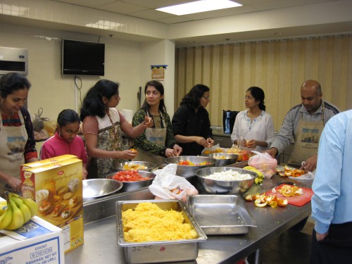 KV volunteers prepare vegetables and other food in the JCNC kitchen in March 2010.